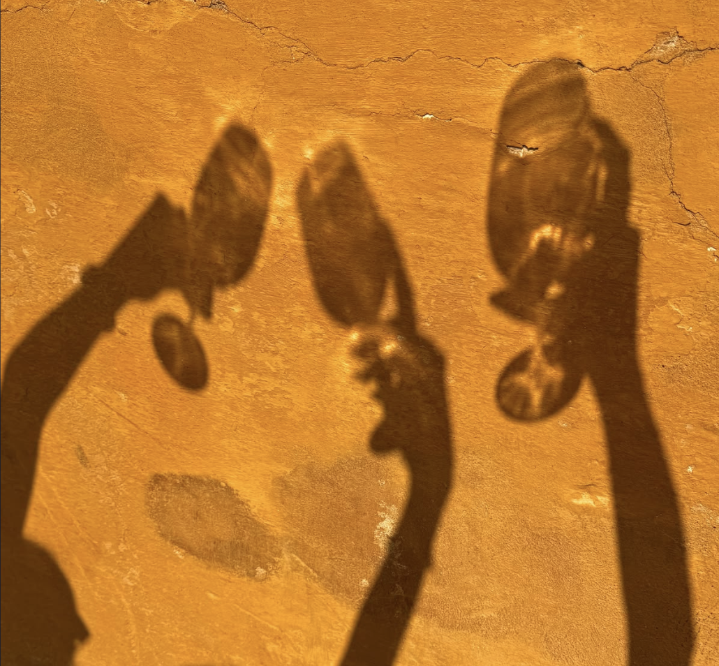 Shadows of friends raising drinks